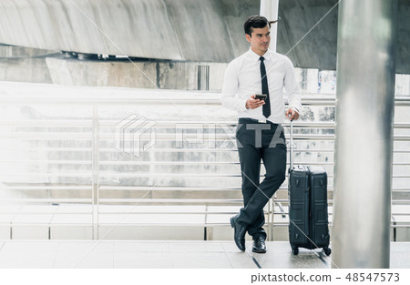 Business man standing with Luggage Trip concept Business man standing with Luggage Trip concept 48547573