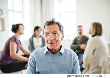 A portrait of senior depressed man during group therapy. 48548119