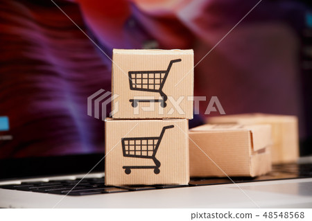 Online shopping . ecommerce and delivery service concept : Paper cartons with a cart or trolley logo 48548568