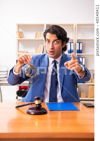 Young handsome judge sitting in courtroom   48549411