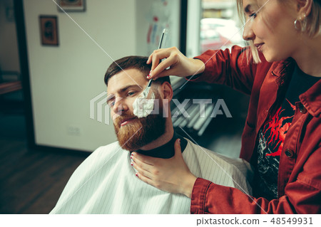 Client during beard shaving in barber shop Client during beard shaving in barber shop 48549931