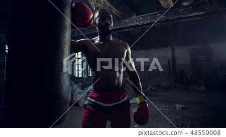 Hand of boxer over black background. Strength, attack and motion concept 48550008