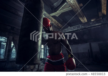 Hand of boxer over black background. Strength, attack and motion concept 48550013