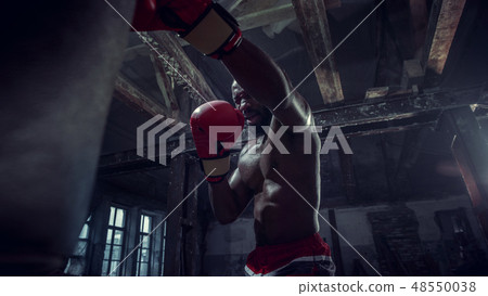Hand of boxer over black background. Strength, attack and motion concept 48550038
