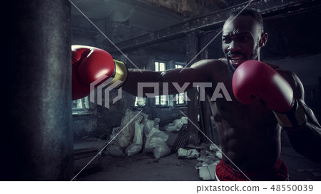 Hand of boxer over black background. Strength, attack and motion concept 48550039