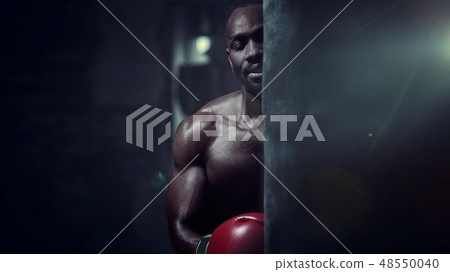 Hand of boxer over black background. Strength, attack and motion concept Hand of boxer over black background. Strength, attack and motion concept 48550040