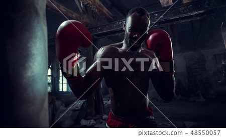 Hand of boxer over black background. Strength, attack and motion concept 48550057