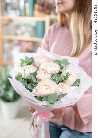 beautiful fresh cut bouquet of mixed flowers in woman hand. the work of the florist at a flower shop 48551188