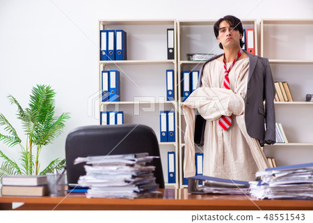 Crazy young man in straitjacket at the office  48551543