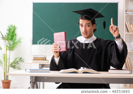 Graduate student in front of green board  48551693