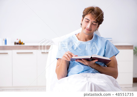 Young male patient lying on couch in hospital  48551735