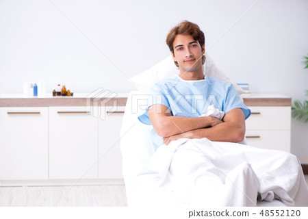 Young male patient lying on couch in hospital  48552120