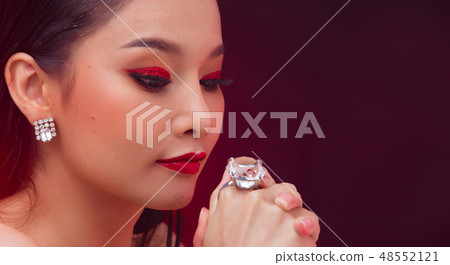 Young Asian black hair fur woman fire red screen 48552121