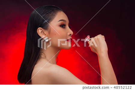 Young Asian black hair fur woman fire red screen 48552122