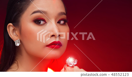 Young Asian black hair fur woman fire red screen 48552123