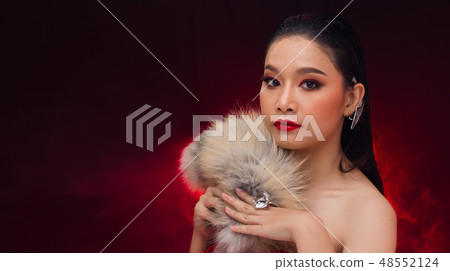 Young Asian black hair fur woman fire red screen 48552124