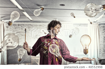 Man artist painting with brush 48552998