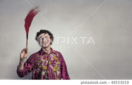 Man artist painting with brush 48553019
