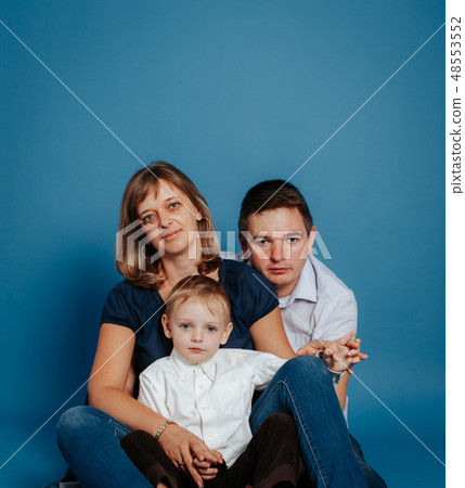 Family mom dad and baby are sitting on the floor. Family mom dad and baby are sitting on the floor. 48553552