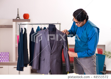 Young male tailor working at workshop  48553572