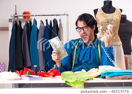 Young male tailor working at workshop  48553578