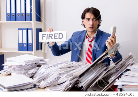 Young businessman employee unhappy with excessive work  48554103