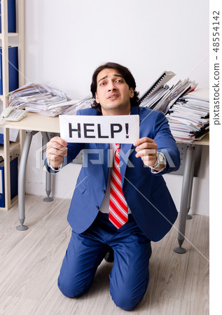 Young businessman employee unhappy with excessive work Young businessman employee unhappy with excessive work 48554142