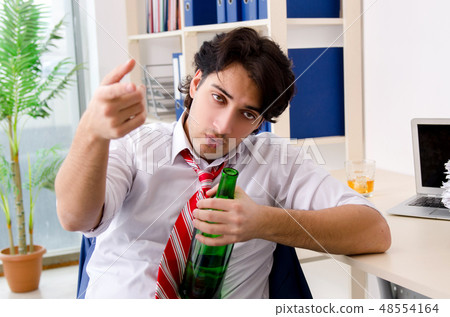 Young businessman employee drinking in the office  48554164