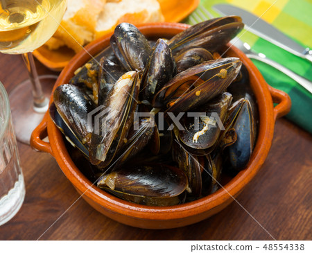 French dish - mussels with onion sauce French dish - mussels with onion sauce 48554338
