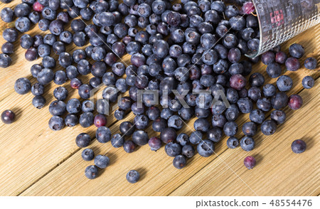 Blueberries on wooden board 48554476