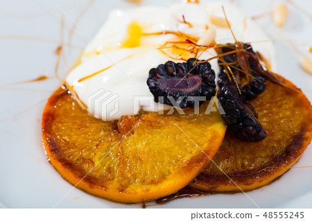 Glazed orange with caramel, dewberries and yogurt 48555245