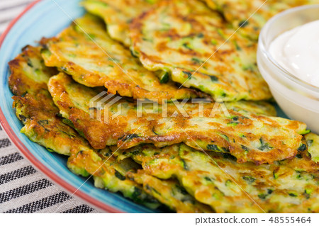 Pancakes from courgettes is tasty vegeterian dish Pancakes from courgettes is tasty vegeterian dish 48555464