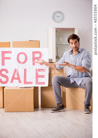 Young man offering home for sale and moving out  48555904