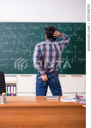 Funny male math teacher in the classroom  48556656