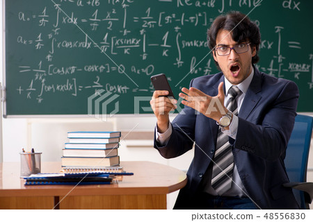 Young male math teacher in classroom  48556830