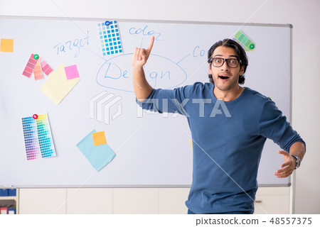 Young handsome designer working at the project Young handsome designer working at the project 48557375