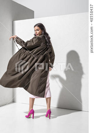Brunette model in stylish clothing and accessories posing in studio Brunette model in stylish clothing and accessories posing in studio 48558437