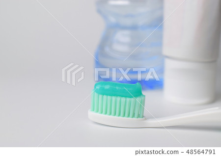 Toothbrush and toothpaste on blurred background 48564791