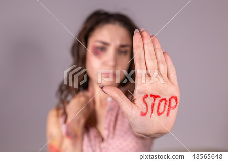 Domestic violence, protesting and people concept - brunette woman expressing denial with STOP on her Domestic violence, protesting and people concept - brunette woman expressing denial with STOP on her 48565648