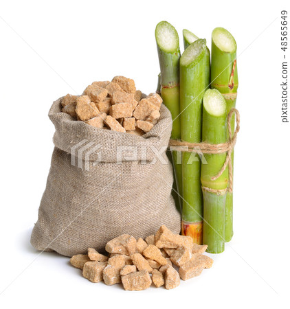 Sugar cane and brown sugar. Isolated on white 48565649