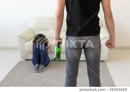 domestic violence, alcoholic and abuse concept - drunk man with bottle abusing his wife lying on the 48565669