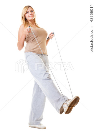 sporty girl plus size doing exercise with jump rope. sporty girl plus size doing exercise with jump rope. 48566014
