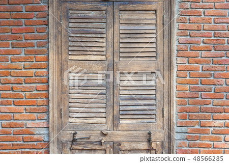Wooden door with red bricks wall 48566285