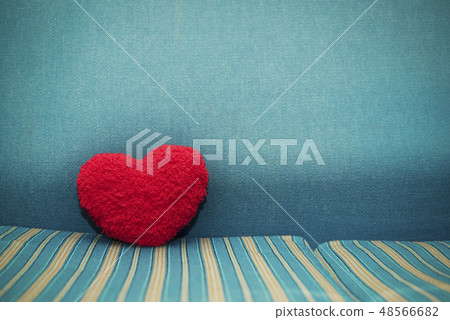Red heart on floor with blue background. 48566682