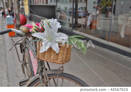 Old bicycle decorated with flowers in the street 48567928