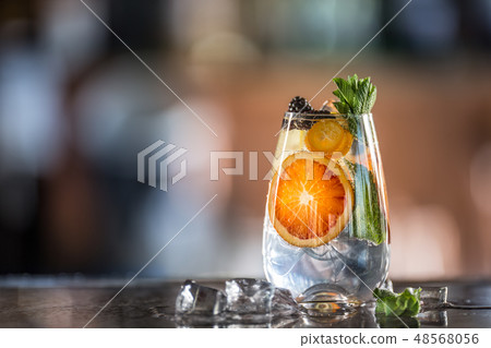Gin tonic cocktailwith fresh tropical fruit on bar counter in pup or restaurant Gin tonic cocktailwith fresh tropical fruit on bar counter in pup or restaurant 48568056