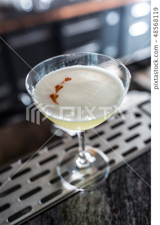 Cocktail drink pisco sour at barcounter in night club or restaurant 48568119
