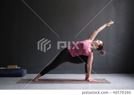 woman doing Extended Side Angle posture  48570160