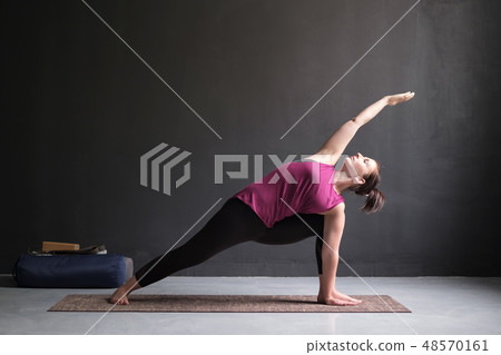 woman doing Extended Side Angle posture woman doing Extended Side Angle posture 48570161