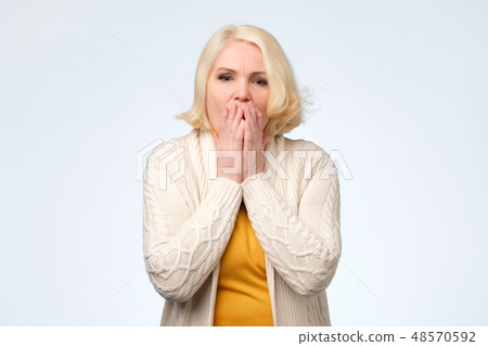 Senior woman covering face with hands Senior woman covering face with hands 48570592